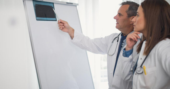 Featured Image – Constructive Feedback- A Guide for Managers Concentrated medical colleagues examining x-ray together